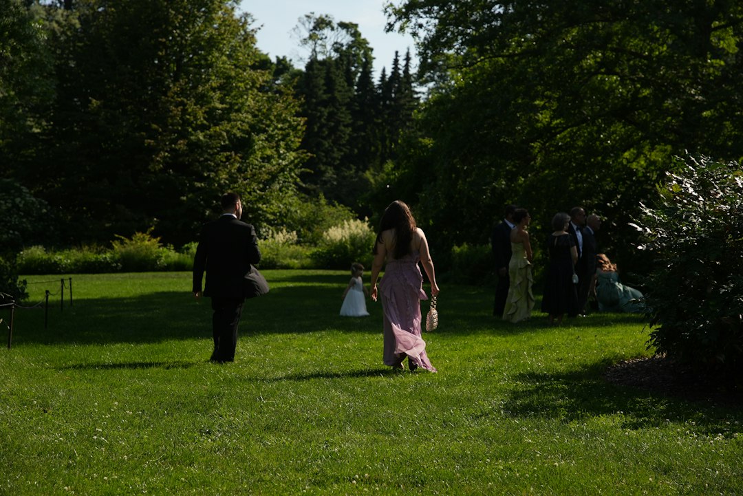 Wedding guests walking together on a green lawn